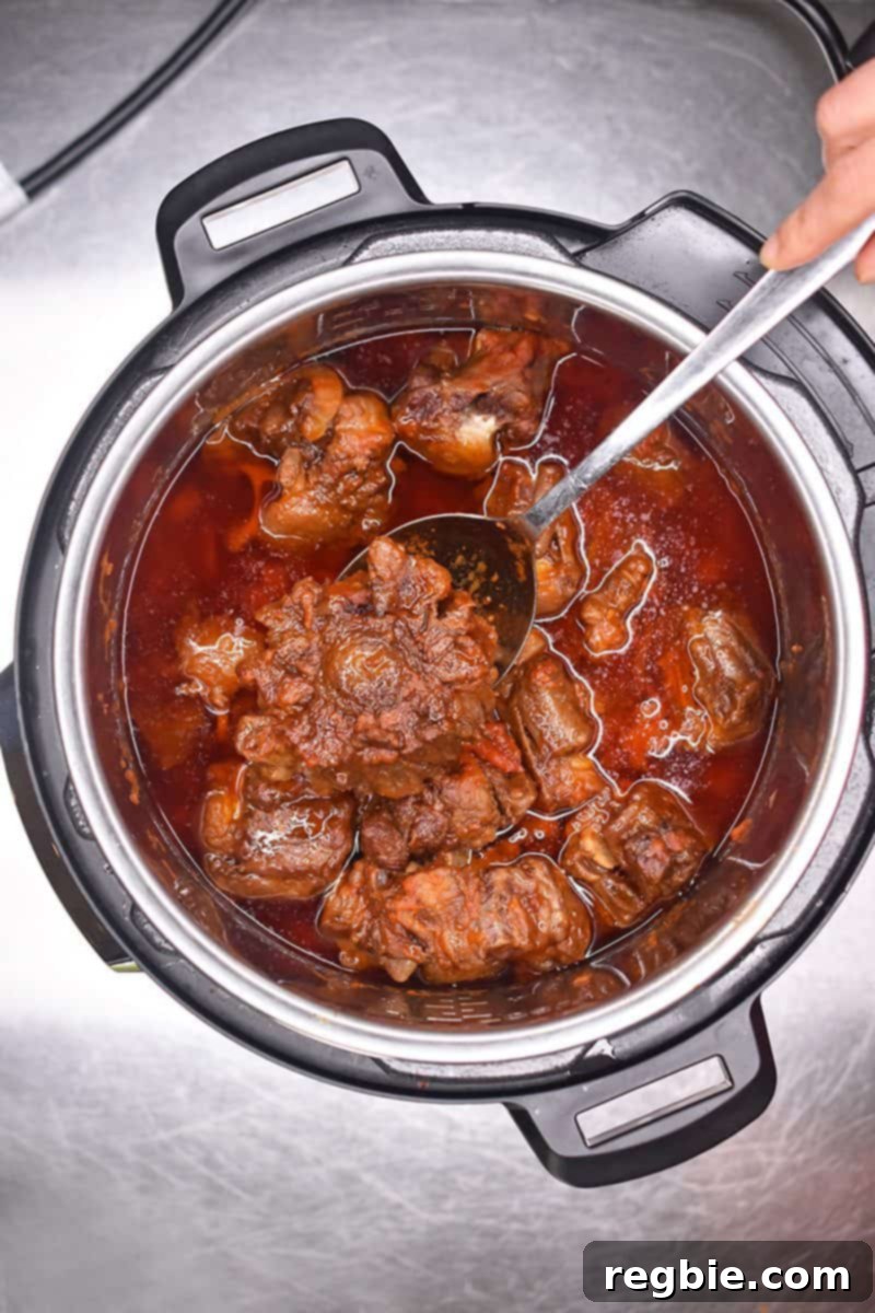 Overhead shot of Instant Pot Oxtail Stew in an open Instant Pot.
