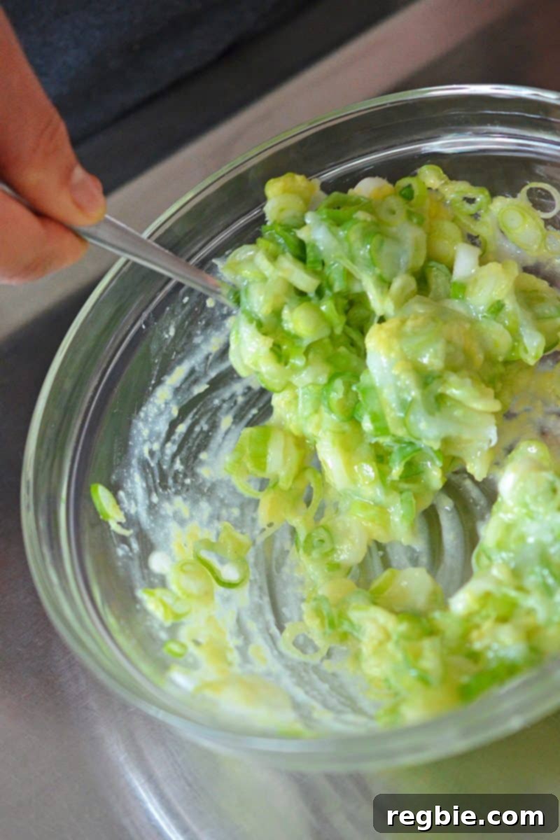 The ginger scallion sauce is thoroughly mixed in a bowl, creating an aromatic paste.