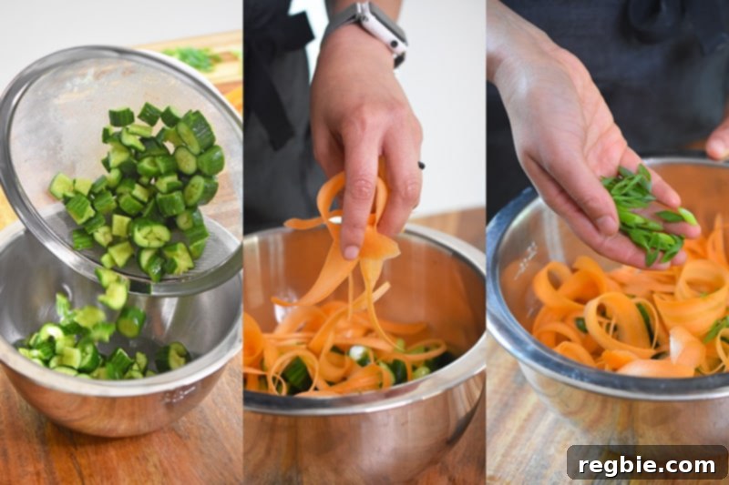 Pour the cucumbers, ribboned carrots, and sliced scallions into a metal bowl for mixing.