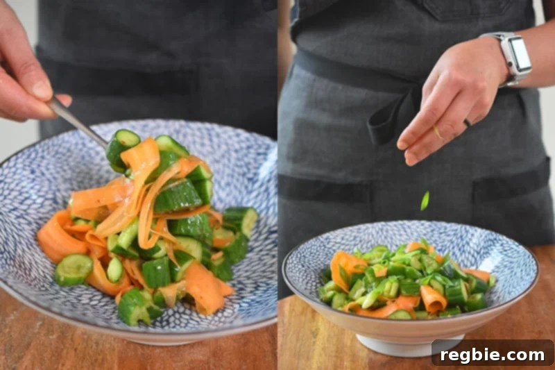 Transferring the paleo and whole30 smashed cucumber and carrot salad into a bowl and topping with sesame seeds and green onions.