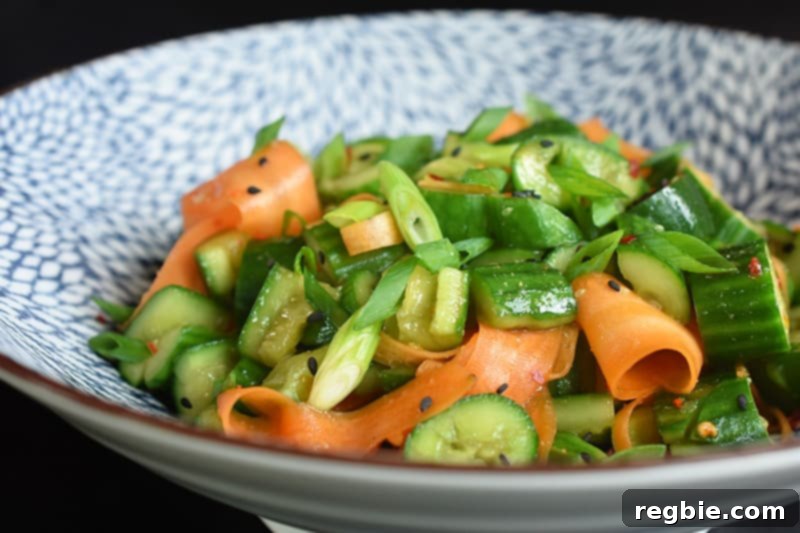 Close up of the paleo and whole30 smashed cucumber and carrot salad in a bowl, ready to be eaten.