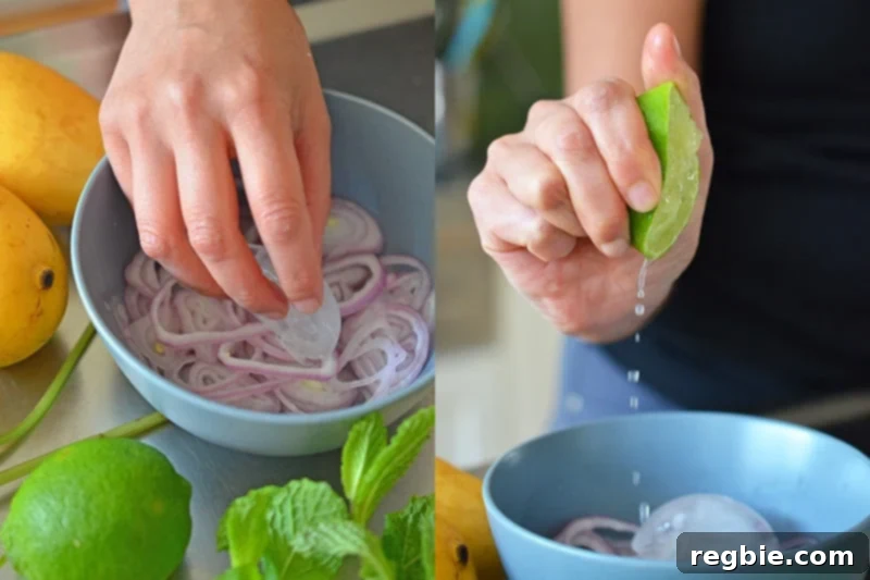 Zesty Mango Cabbage Crunch 3 Sliced red onions in a bowl with someone squeezing fresh lime juice into the bowl, along with an ice cube.