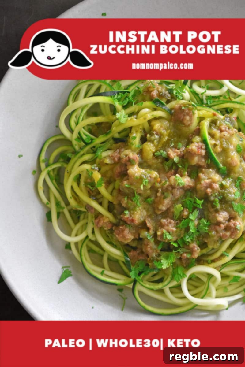 A vibrant overhead shot of a bowl filled with spiralized zucchini noodles generously topped with rich, hearty Instant Pot Zucchini Bolognese. The accompanying labels highlight its paleo, Whole30, and keto compatibility.