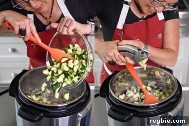 A shot of cut zucchini and minced garlic being added to an open Instant Pot, layering in fresh ingredients.