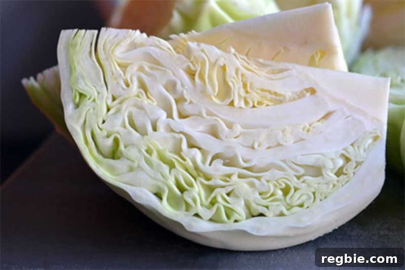 A closeup shot of crisp green cabbage wedges, cut into perfect segments, destined for the slow cooker pork stew.