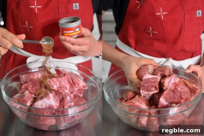 Seasoning the cubed Instant Pot Magic Pork with a generous dusting of Magic Mushroom Powder in a large bowl, ensuring even coverage.