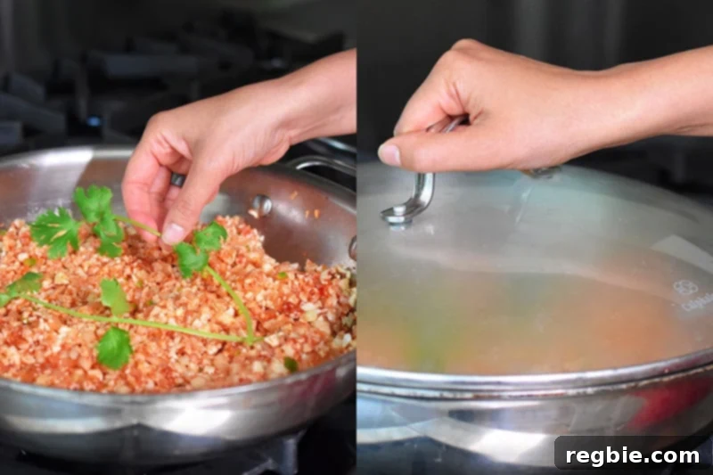A sprig of fresh cilantro is being added to the low-carb Mexican Cauliflower rice before covering the pan to simmer, enhancing its aroma.