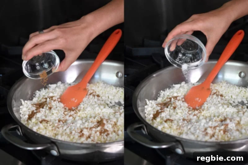 Seasonings, including ground cumin and kosher salt, are being tossed into the pan with the cauliflower to create flavorful Mexican Cauliflower Rice.