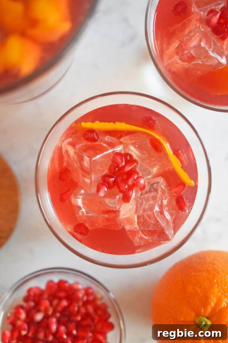 Overhead shot that shows a few glasses filled with Whole30-friendly Pomegranate Orange Mocktail
