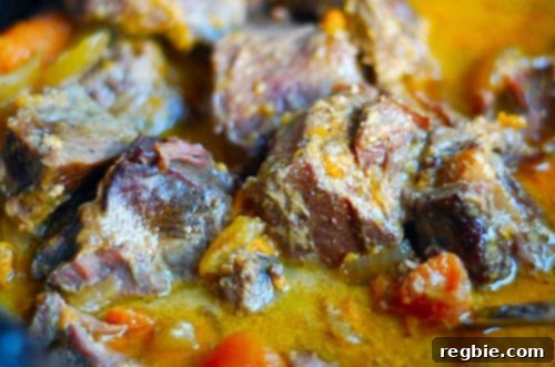 Slow Cooker Thai Yellow Curry with Grass Fed Beef Brisket cooked and ready to serve, garnished with fresh herbs.