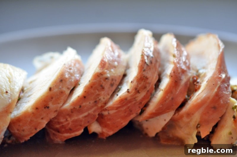 Delectable Prosciutto Chicken Rolls 4 A side view of perfectly sliced Chicken Prosciutto Involtini elegantly presented on a platter. The image showcases the juicy interior of the chicken and the crisp prosciutto exterior, with the slices artfully arranged to highlight the dish's gourmet appeal and inviting texture.