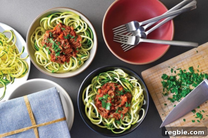 An inviting overhead view of multiple bowls, each generously topped with Sunday Gravy and served over a bed of vibrant zucchini noodles.