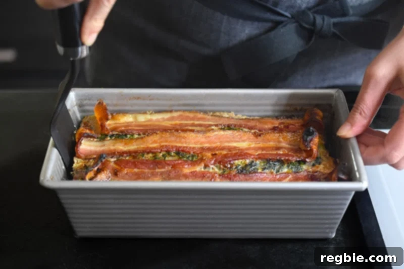 Easy Whole30 Paleo Keto Meatloaf Nut and Dairy Free 13 Using a spatula to carefully remove the fully cooked and rested Easy Meatloaf from the loaf pan onto a cutting surface.