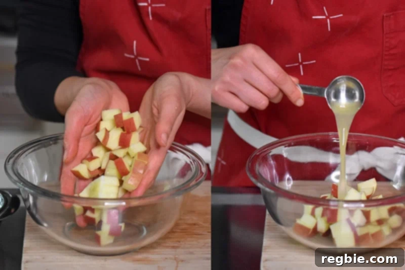 Placing freshly chopped apple cubes and lemon juice into a clear glass bowl, ready for tossing to prevent oxidation.