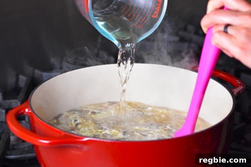 Zesty Whole30 Gluten Free Hot and Sour Soup 11 Pouring rice vinegar into the Hot and Sour Soup off the heat, for the perfect tangy finish.