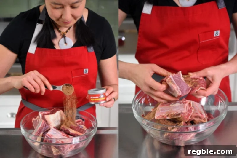 A woman is adding a tablespoon of Magic Mushroom Powder to a bowl filled with short ribs. She uses her hands to toss them together to ensure even seasoning.
