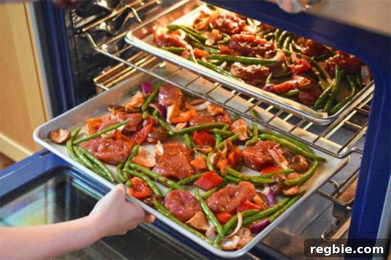 Sticky Sweet and Spicy Sheet Pan Pork 11 Placing the two sheet pans on two different racks in the oven.