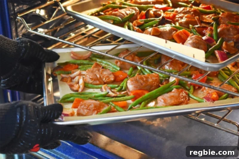 Sticky Sweet and Spicy Sheet Pan Pork 12 Switching the sheet pans from the top to bottom oven rack and vice versa.