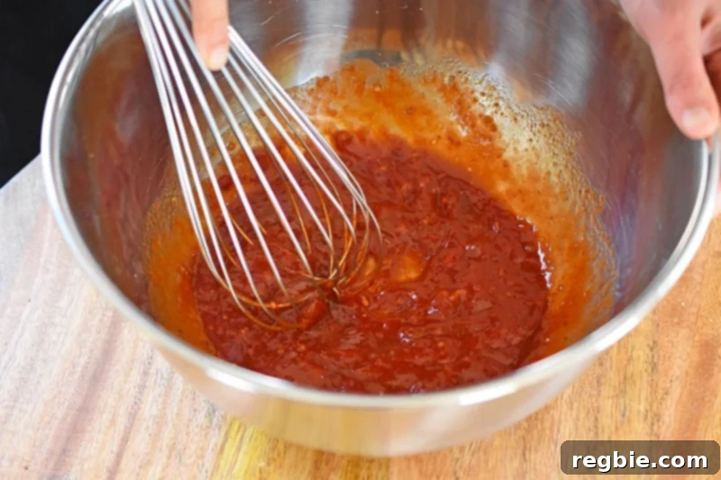 Sticky Sweet and Spicy Sheet Pan Pork 7 Whisking the marinade until smooth.