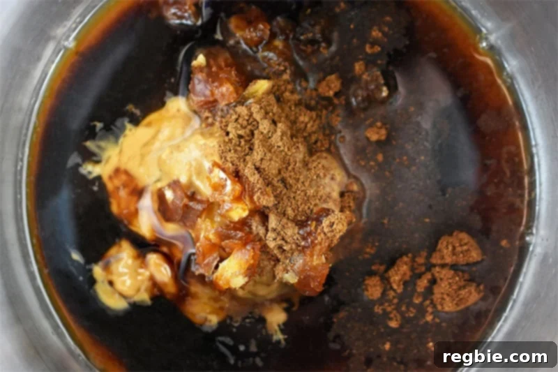 An overhead shot of all the paleo hoisin sauce ingredients mixed together in a saucepan, ready for cooking.