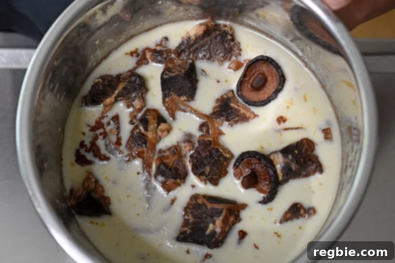 An overhead shot of chilled Instant Pot Chinese Beef Stew in the metal insert, with a top layer of hardened white fat.