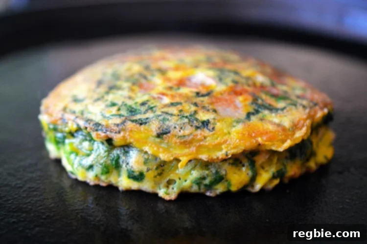 Wholesome Whole30 Keto Egg Foo Young 9 An Egg Foo Young savory Chinese pancake is finished frying on a cast iron skillet.