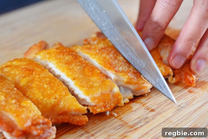 Cutting a piece of Whole30, keto, and paleo-friendly Cracklin' Chicken for Chinese Chicken Salad