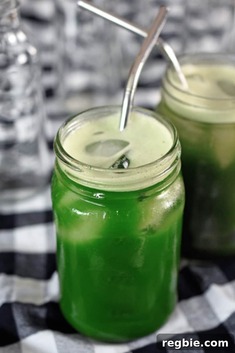 Chilled Matcha Infusion 3 A shot of two mason jars filled with icy cold brew matcha with metal drinking straws inside, ready for enjoyment.