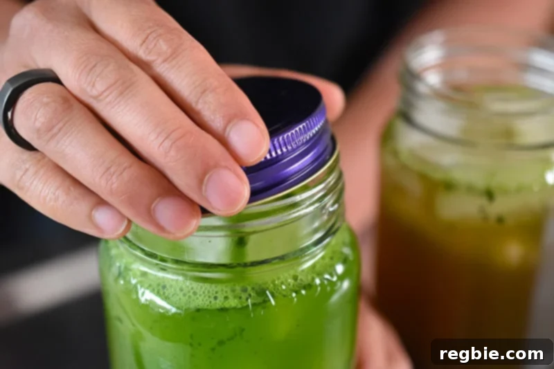 Chilled Matcha Infusion 9 Twisting a lid securely on a mason jar filled with cold brew matcha ingredients, preparing for vigorous shaking.