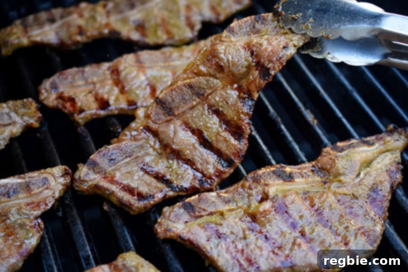 Classic Korean BBQ Kalbi 12 A closeup shot of paleo and whole30 kalbi cooking on the grill.