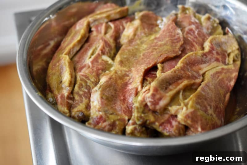 Classic Korean BBQ Kalbi 4 A bowl filled with LA galbi that is marinating in Whole30-friendly sauce for Korean BBQ short ribs