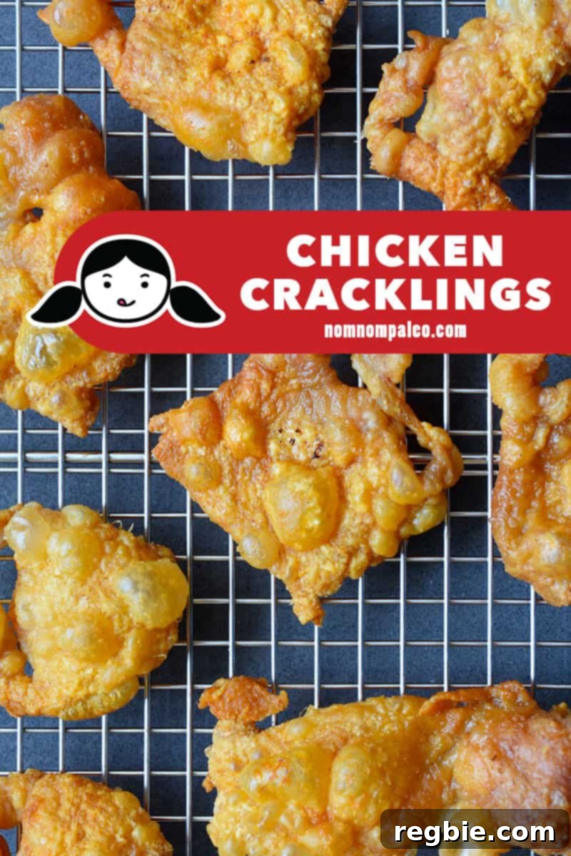 An overhead shot of a tray of crispy chicken skins cooling on a wire rack, showcasing their perfect texture.