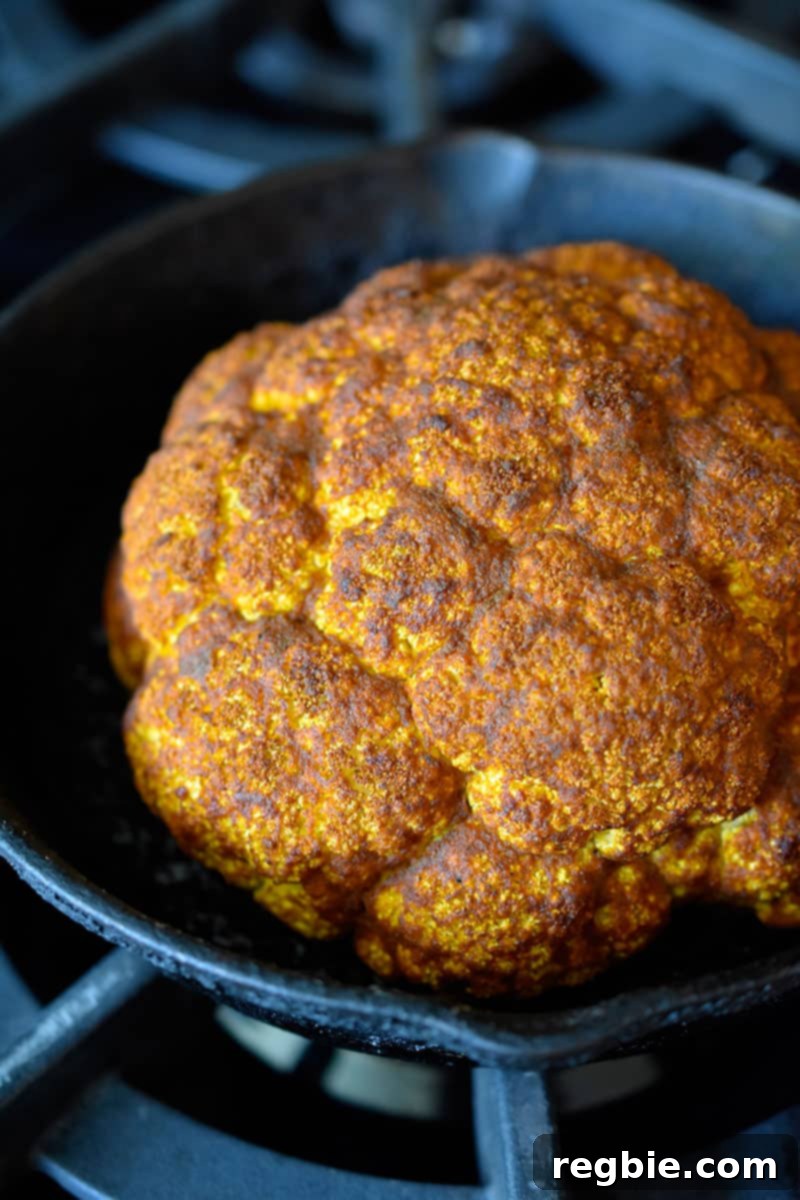 An overhead shot of Tandoori Whole Roasted Cauliflower, perfectly golden brown and ready to be served from the oven.