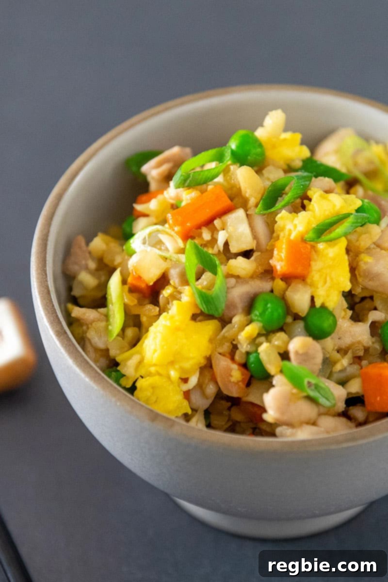 Close up shot of Healthy Cauliflower Chicken Fried Rice, a Whole30-friendly and low-carb one-pan dinner.