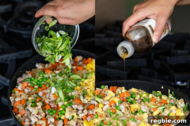 Adding scallions and toasted sesame oil into the pan of cauliflower chicken fried rice.