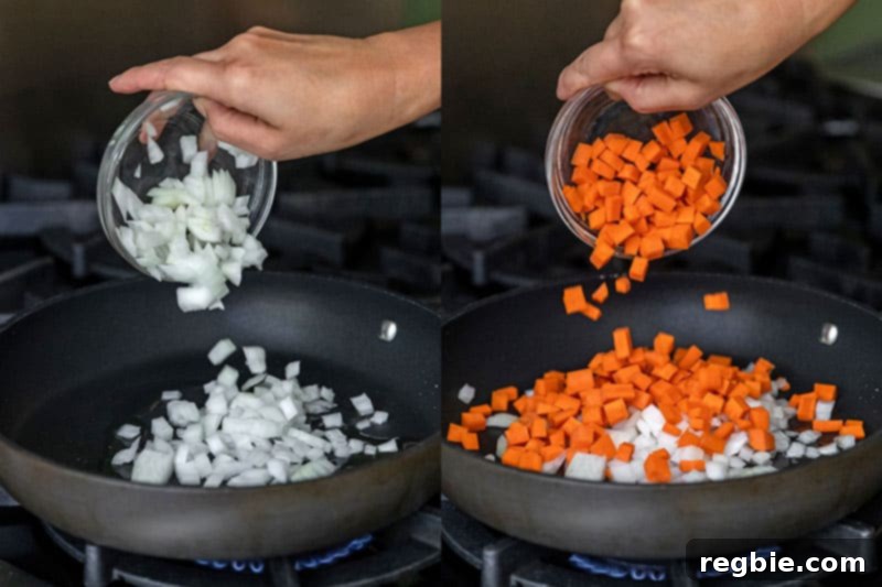 Adding diced onions and carrots to a non-stick skillet to make Whole30 Cauliflower Chicken Fried Rice.