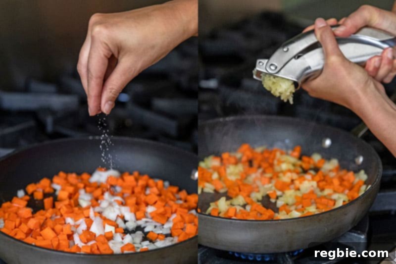 Adding salt and garlic to a pan with sautéed onions and carrots.