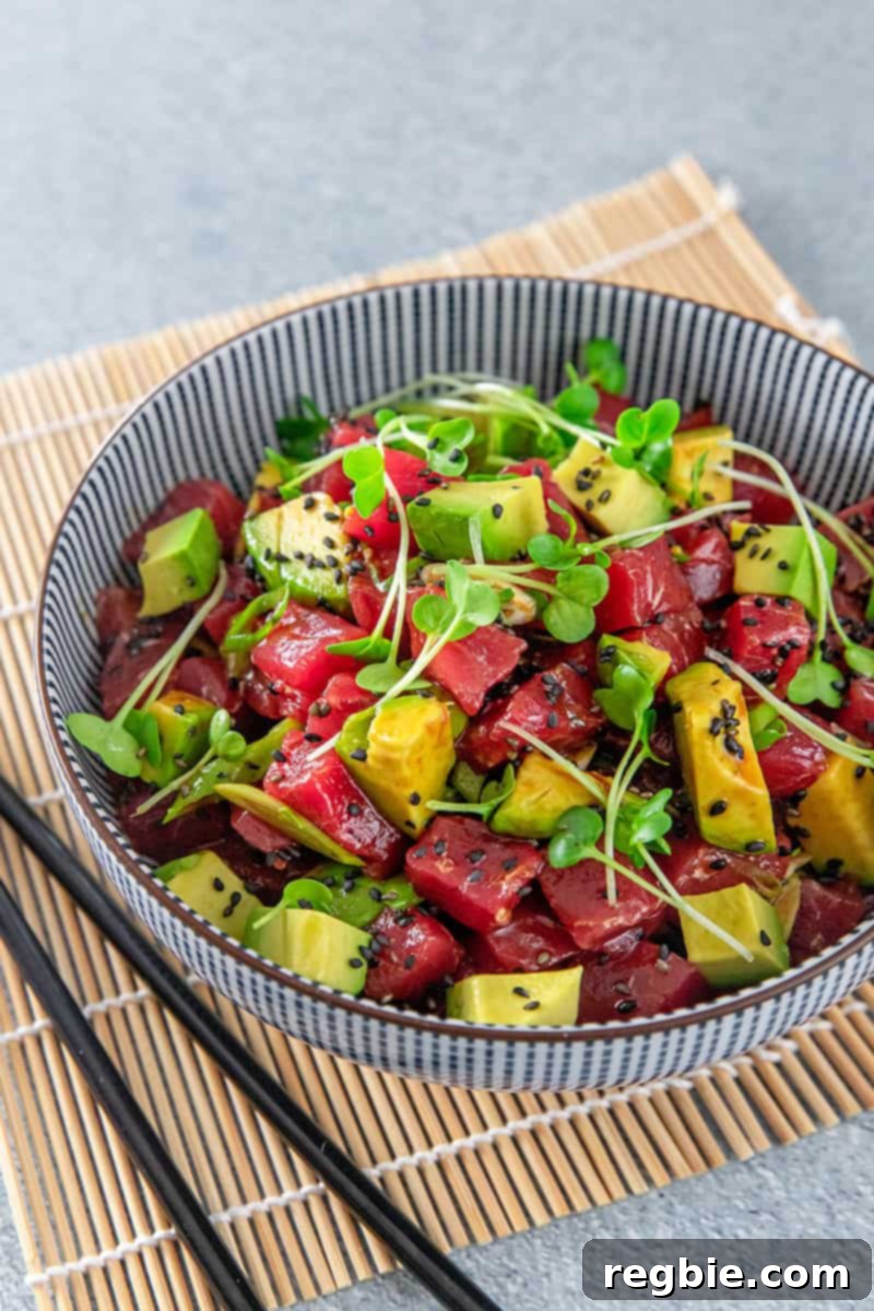 Clean Eating Tuna Avocado Poke 3 Closeup shot of Whole30 compliant Tuna Poke with Avocado, showcasing the fresh diced tuna and creamy avocado cubes with green onion garnish.