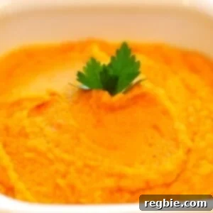 A white bowl containing carrot and parsnip puree.