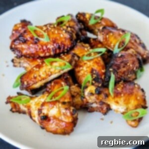 A white plate filled with Whole30, gluten-free, paleo Chinese Chicken Wings, a super easy game day appetizer!