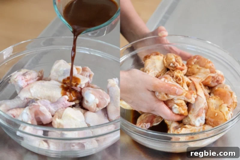 Pouring a generous amount of Whole30 marinade over fresh Chinese Chicken Wings and expertly tossing them by hand to ensure even coating.