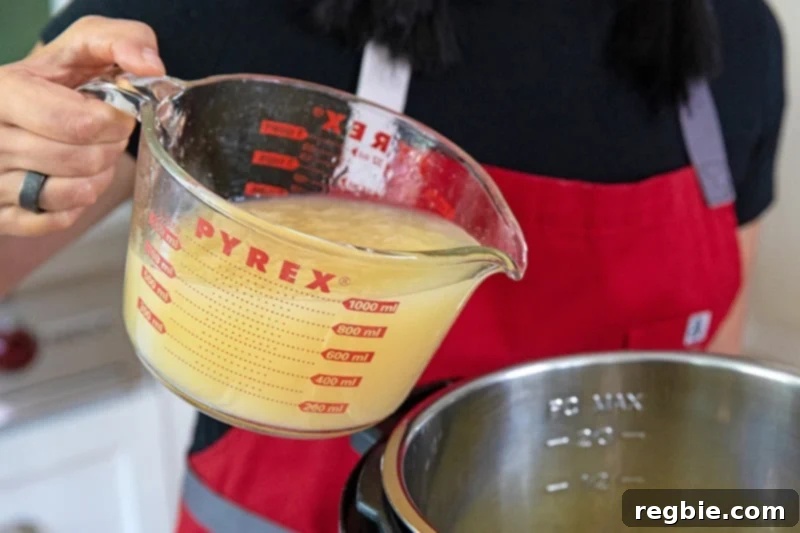 Pouring rich bone broth into an Instant Pot, setting the foundation for a delicious Instant Pot Vegetable Soup.