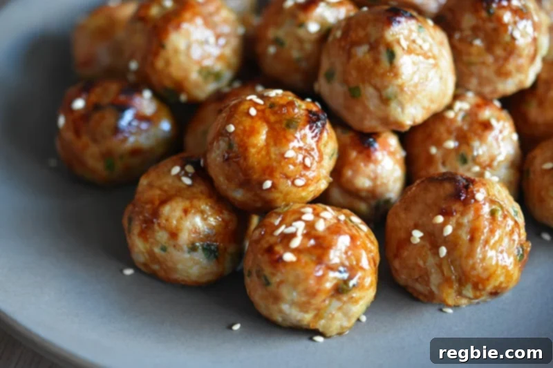 A side shot of a platter of paleo tsukune, gluten-free Japanese ground chicken meatballs, ready to be served.