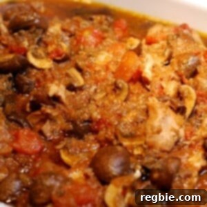 A microwave safe dish is filled with slow cooker chicken cacciatore.