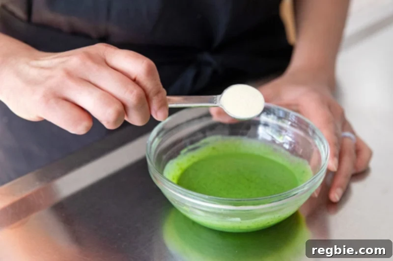 Creamy Paleo Dairy Free Matcha Pudding 5 A spoonful of gelatin powder being added to the matcha and coconut milk mixture, beginning the blooming process for creamy paleo matcha pudding.