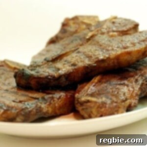 A perfectly seared medium-rare grass-fed T-bone steak, cooked using sous vide and finished on the grill, presented on a plate.