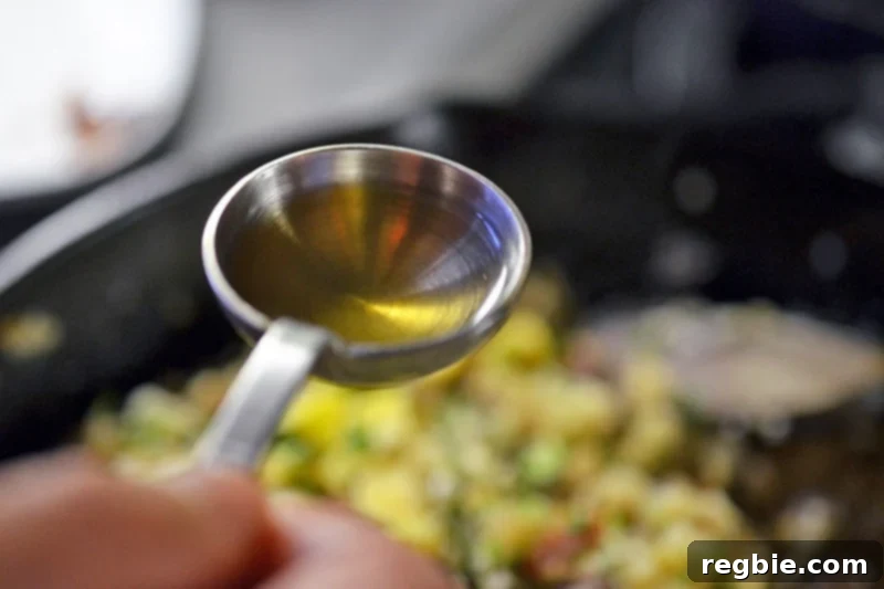 Better-Than-Takeout Asian Cauliflower Fried Rice 14 Adding a spoonful of savory fish sauce to flavor the Asian Cauliflower Fried Rice
