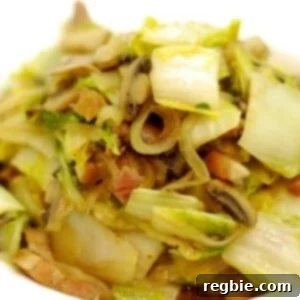 A bowl of the Whole30 and paleo recipe of stir fried napa cabbage with mushrooms and bacon.