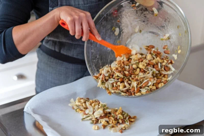 Indulgent Chocolate Cherry Granola Paleo Vegan Gluten Free 9 Transferring the cherry chocolate paleo granola onto the parchment lined baking sheet, ready for even spreading.