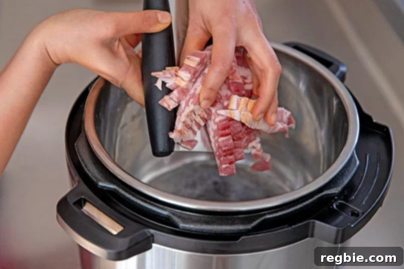 Adding thinly sliced bacon to an Instant Pot set on the sauté function.